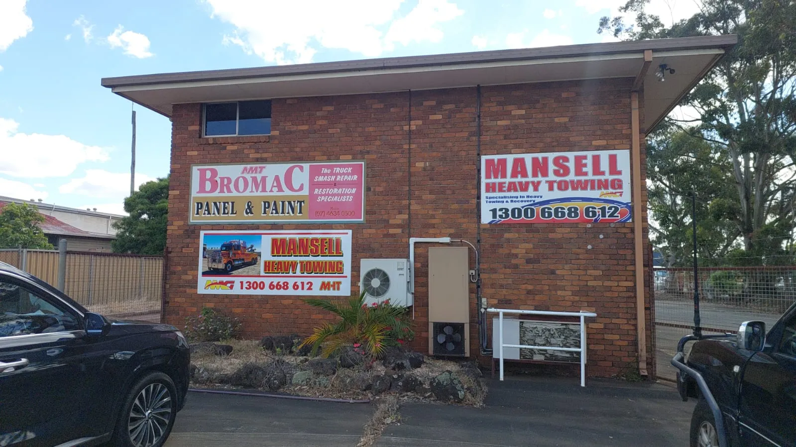 Brick premises with Mansell Heavy Towing and BromaC Panel & Paint signage