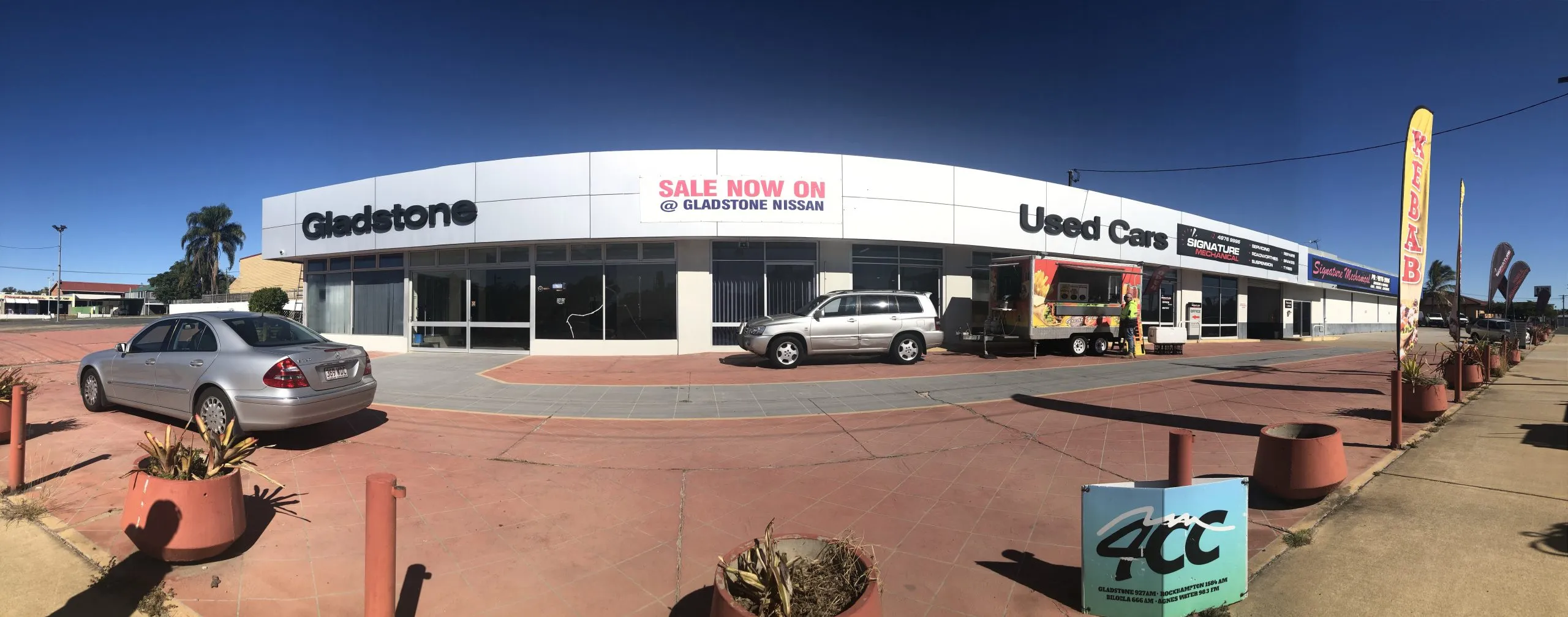 Wide panorama of the Gladstone Nissan used-car dealership frontage