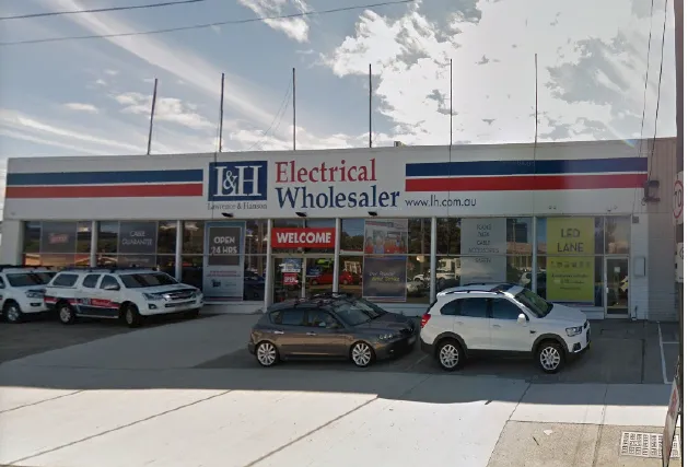 L&H Electrical Wholesaler retail shopfront with cars parked outside
