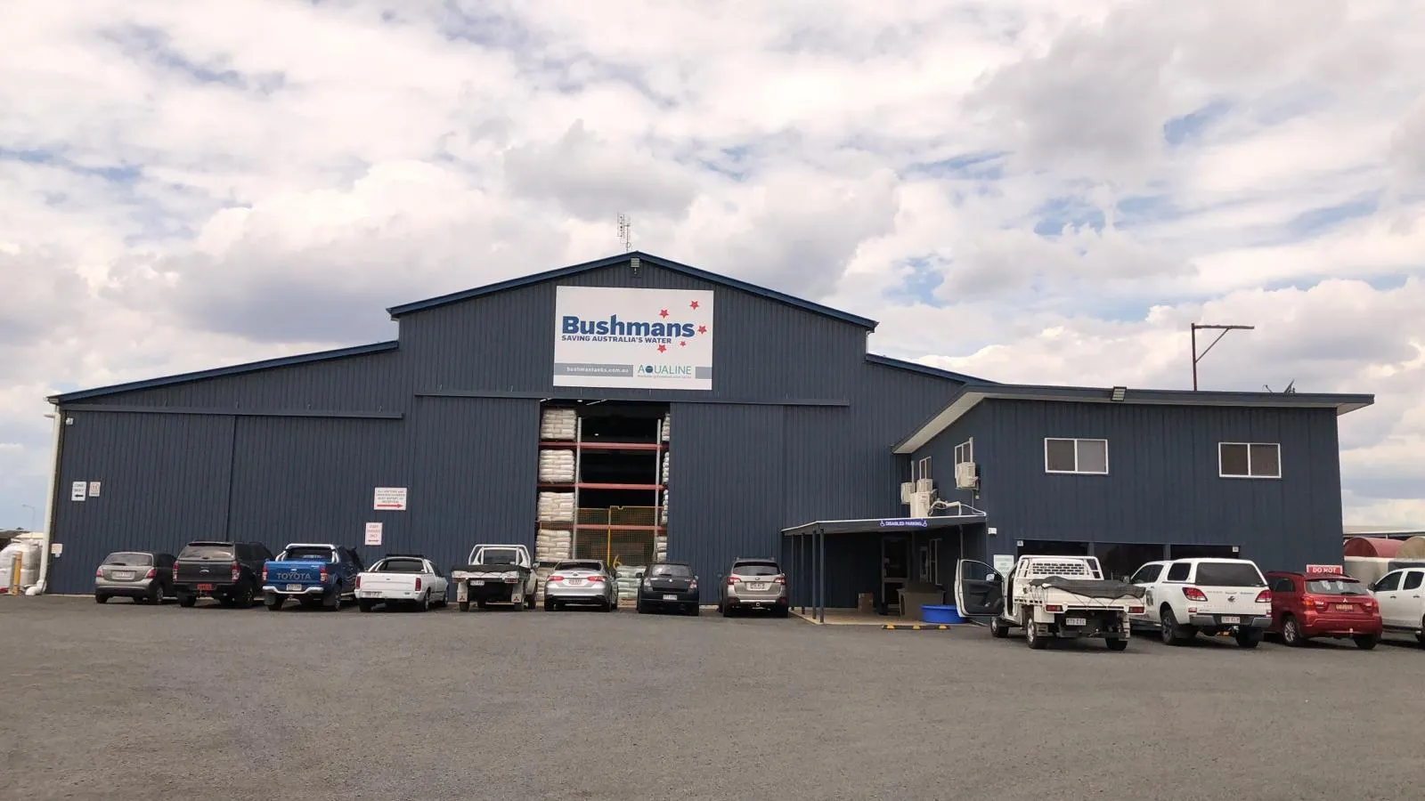 Bushmans water-tank manufacturing warehouse with a full staff car park