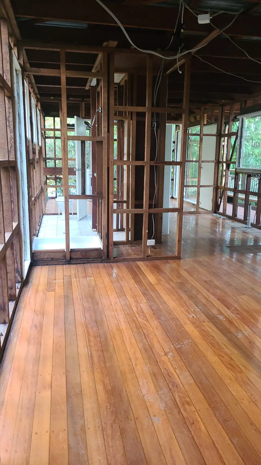 Open interior with restored timber floor after lining removal