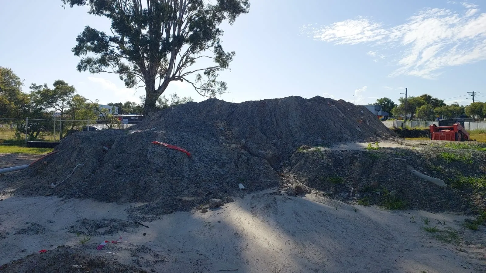 Asbestos fragments being removed from soil
