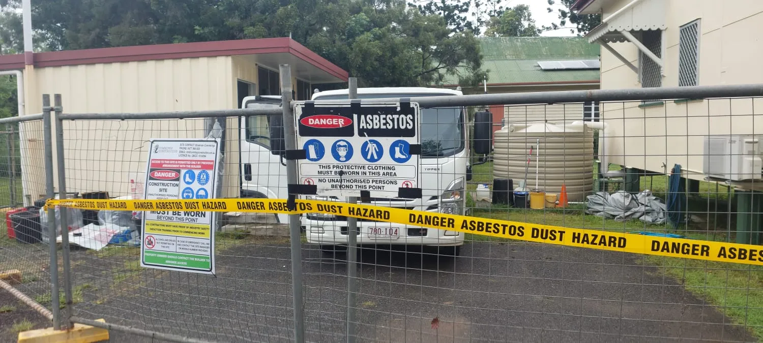 Site fenced with danger asbestos barrier tape